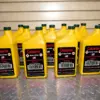 Multiple yellow Caluanie Muelear Oxidize bottles with dark green caps arranged for bulk industrial supply
