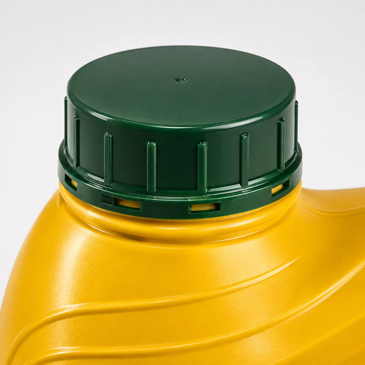 Close-up of dark green tamper-evident cap on yellow Caluanie Muelear Oxidize container